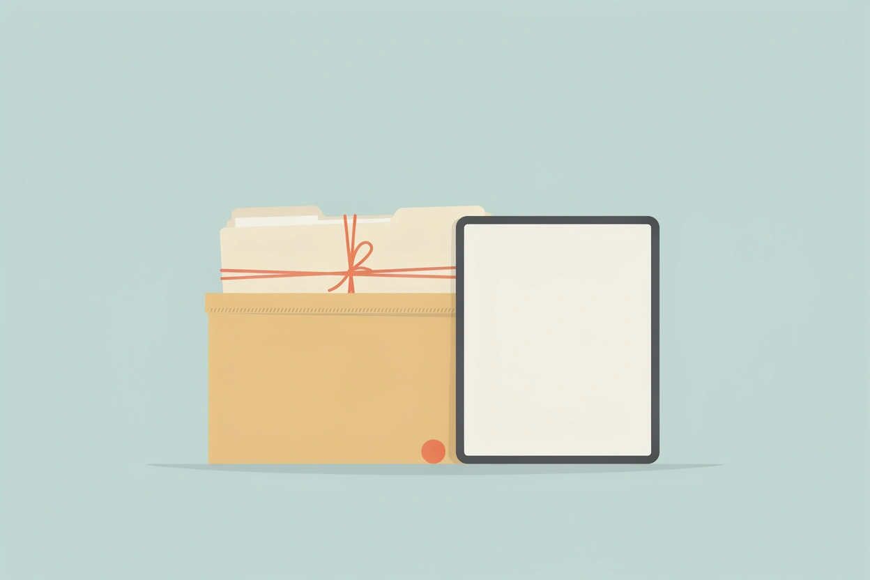 A cardboard file box of paper folders tied with coral string beside a tablet with a blank screen.