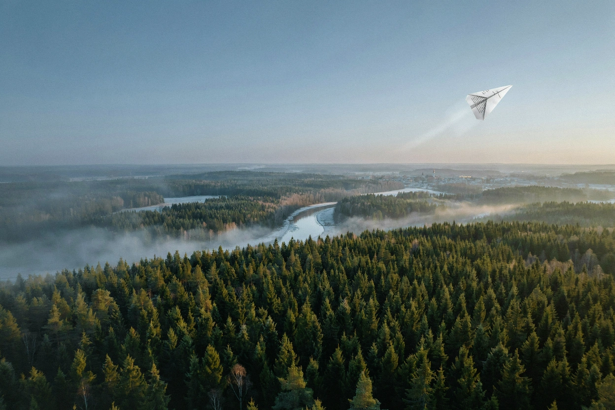A paper airplane folded from a document flying over a forest and river at sunrise